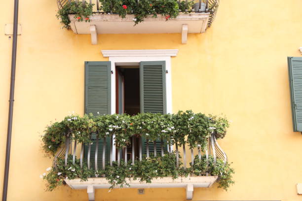 a balcony with flowers and plants