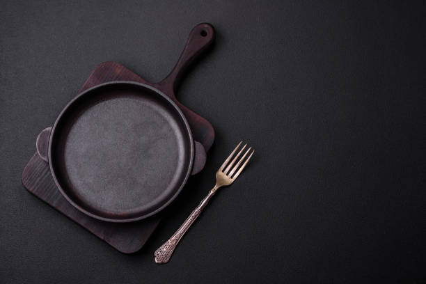 istock Empty round cast iron skillet on dark textured concrete background 1461131769