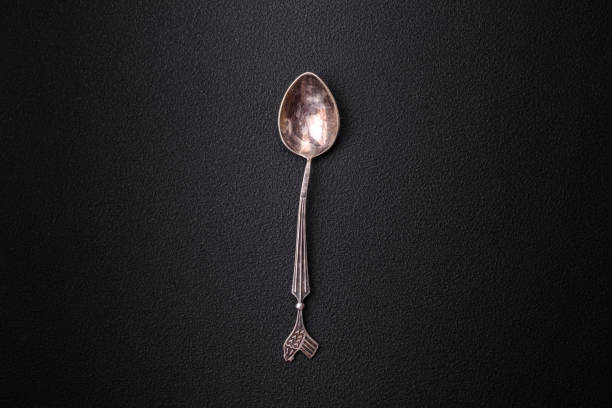 istock Empty metal spoon on dark textured concrete background 1461132289