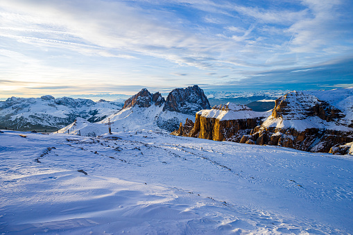 photo of the sassolungo at sunset. the photo was taken in winter from pordoi and shows the sassolungo group in the dolomites in val di fassa.