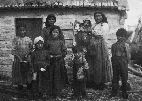 Pelican Narrows, Saskatchewan, Canada - 1919. Two Cree mothers with their children at Pelican Narrows in Saskatchewan, Canada. File source is film. Ca. 1919