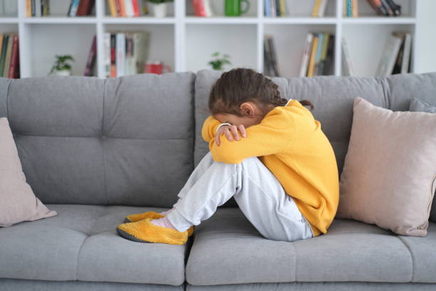 istock Unhappy ,Alone and Sad Girl On Sofa 1461144479