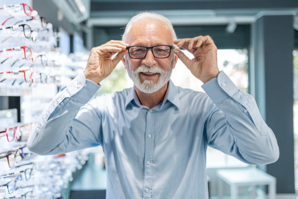 istock Senior man looking at camera buying eyeglasses 1461145655