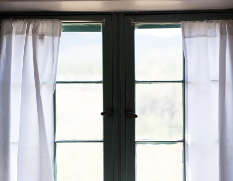 Window with Old-Fashioned White Curtains