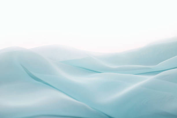 istock Wavy surface of a pastel blue chiffon fabric as a background with copy space. Photo in perspective 1461150009
