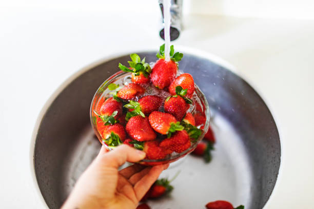 Free Stock Photo of Hand dipping strawberry into water with splashes ...