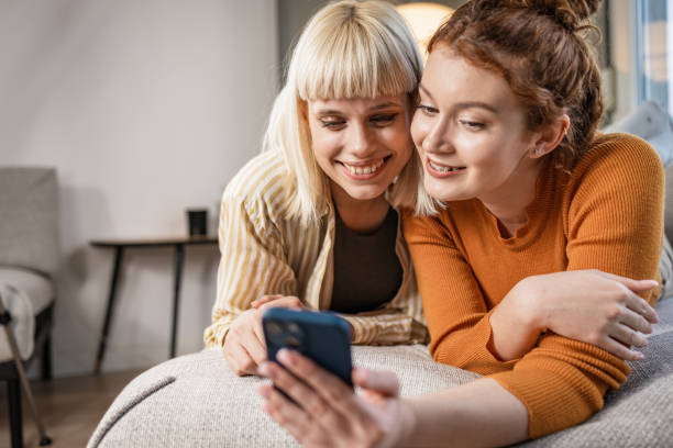 istock Two young woman looking at the phone 1461156066