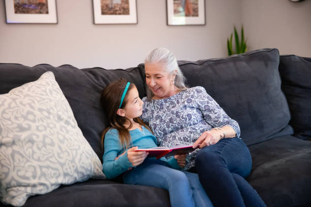 istock Grandmother and Granddaughter reading a book 1461156190
