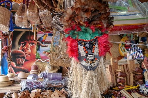 Wooden face mask decorated with feathers and fish teeth. Location: Mercado Ver o Peso, Belem, State of Para, Amazon region, Brazil, South America