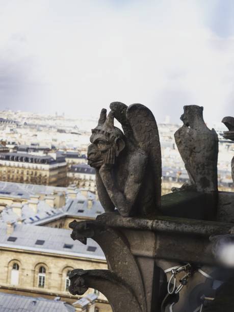 istock Chimera gargoyle mythical figure statue sculpture gothic architecture at Notre Dame cathedral church tower Paris France 1461157088