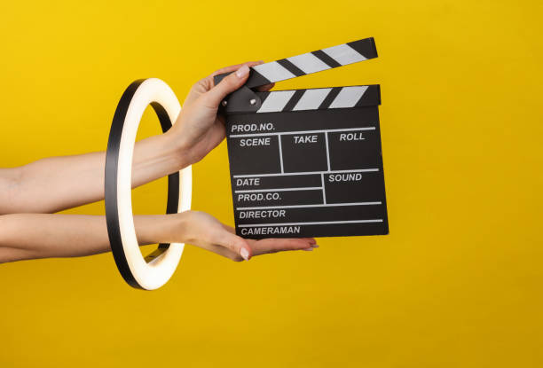 istock Woman's hands holding  through led ring lamp on yellow background. Creative idea. 1461158147