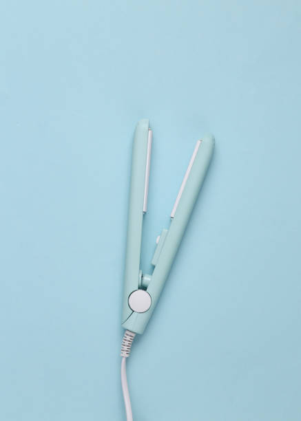 istock Mini hair straightener on a blue background. Top view 1461158272