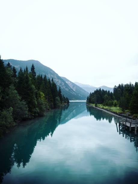 Reflection of blue water Lake Plansee, Tyrol Austria