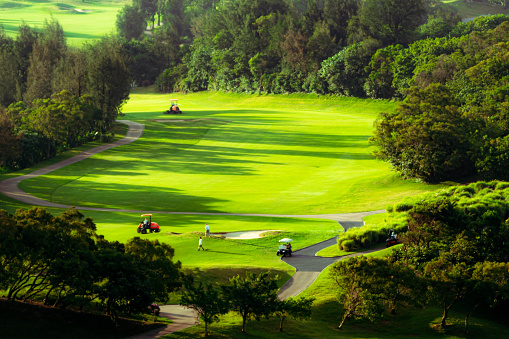 Beautiful golf course illuminated with sunlight at sunrise, green grass space prior to the destruction of a volcanic eruption in Guatemala.
