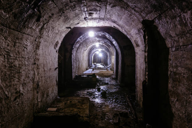istock Vaulted tunnel with concrete walls in old abandoned bunker, mine, drainage, subway, etc 1461163683