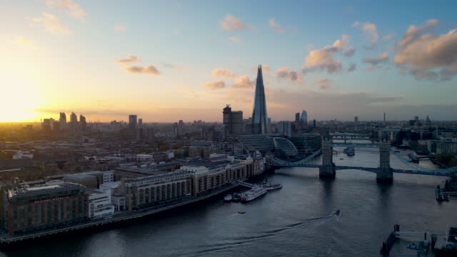 Aerial view of Tower Bridge, River Thames and London financial centre  with skyscraper at golden hour and sunset - 4k video