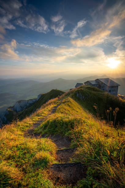 istock A hiking trail on a mountain leading to a house 1461166811