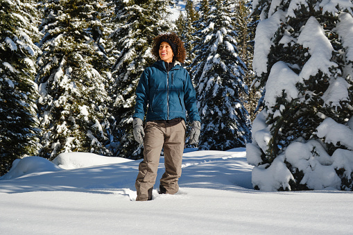 A woman snowshoeing in the Utah USA mountains.