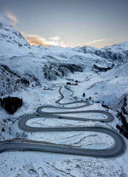 istock A winding pass road in winter during the sunset 1461167226