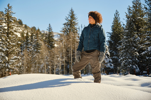 A woman snowshoeing in the Utah USA mountains.