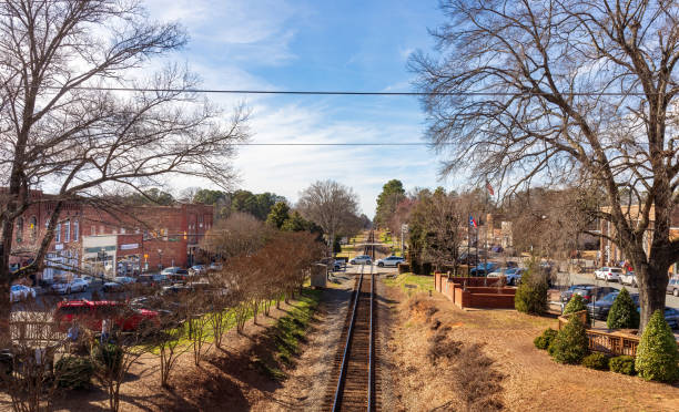 View of railroad tracks and Main St, from bridge, Waxhaw, NC Waxhaw, NC, USA-28 Jan 2023: Wide view from walking bridge down railroad tracks, with North and South Main Streets on a sunny winter day. jacksonville symbol stock pictures, royalty-free photos & images