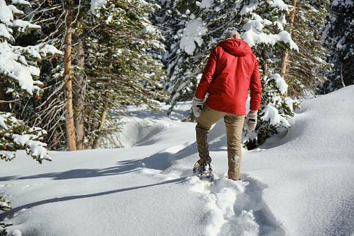 A man snowshoeing in the Utah USA mountains.