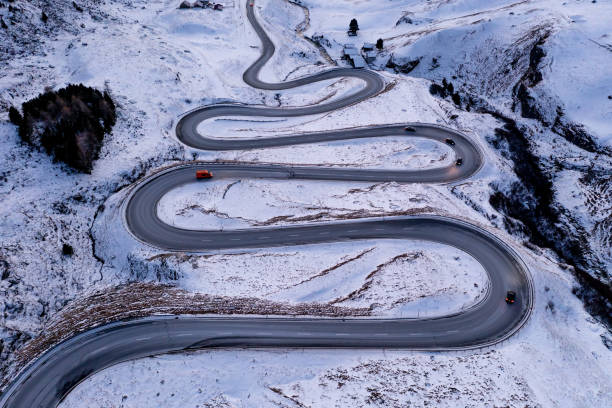 istock A snake shaped pass road in winter photographed from above 1461168414