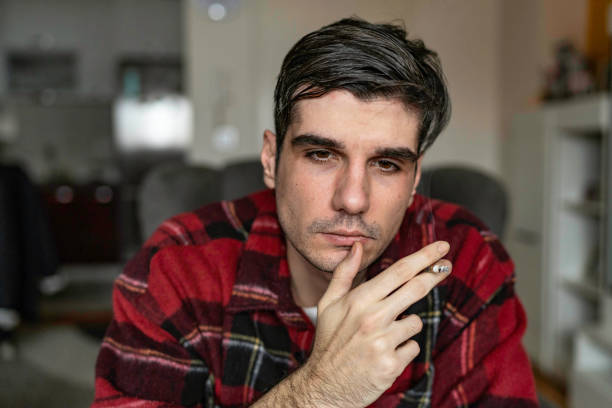 istock Sad unhappy handsome man sitting on the sofa 1461170096