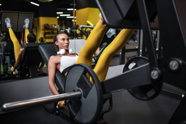 Athletic Female Dominating Leg Press Machine In Gym ripl fitness