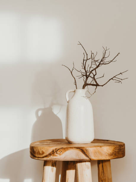 Modern minimalist style interior with ceramic vase with branch on wood table stock photo