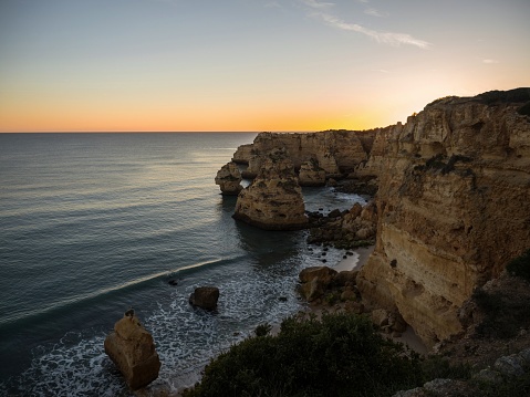 Sunset panorama view of rock cliff coast navy beach Praia da Marinha Caramujeira Lagoa Algarve atlantic ocean sea Portugal Europe