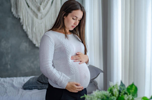 istock Young woman enjoying her first pregnancy at home 1461174636