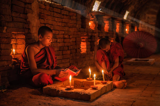 istock Novice buddhist monks contemplating inside temple, Myanmar 1461179512