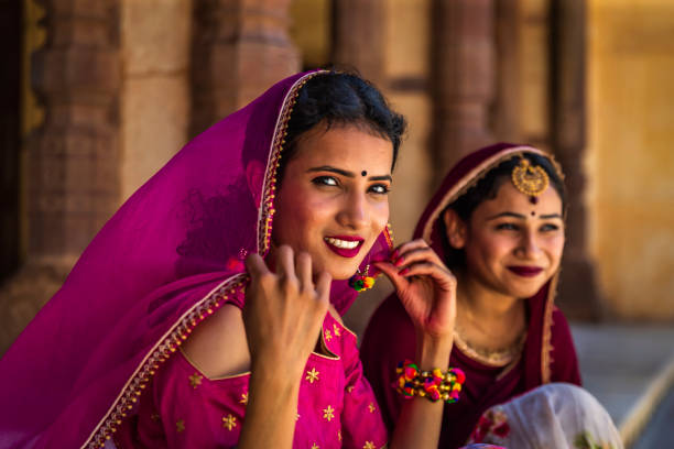 Young Indian women, wearing saris, posing in Jaipur city, Rajasthan.