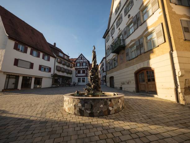 Water fountain spring in pedestrian zone market square of charming town of Riedlingen in Baden-Wuerttemberg Germany Water fountain spring in pedestrian zone market square place of charming historic old town village city of Riedlingen in Baden-Wuerttemberg Germany Europe riedlingen stock pictures, royalty-free photos & images