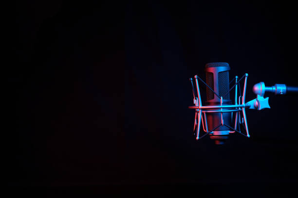 istock a black microphone on black background under the neon light. podcasting, singing, and recording background. 1461181680