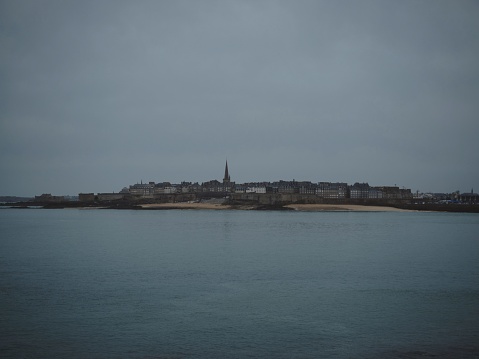 Panorama view of atlantic coast walled city historical old town of Saint Malo island at blue hour from Dinard Brittany France Europe