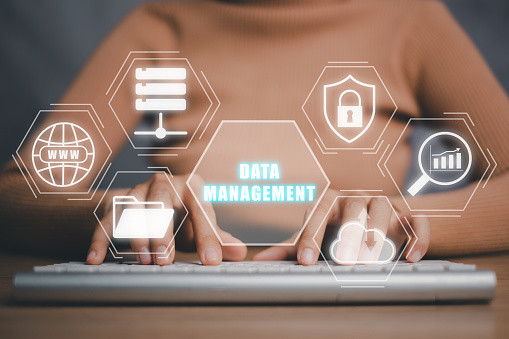 Data management concept, Person hand typing on keyboard with data management icon on virtual screen, information technology concept.