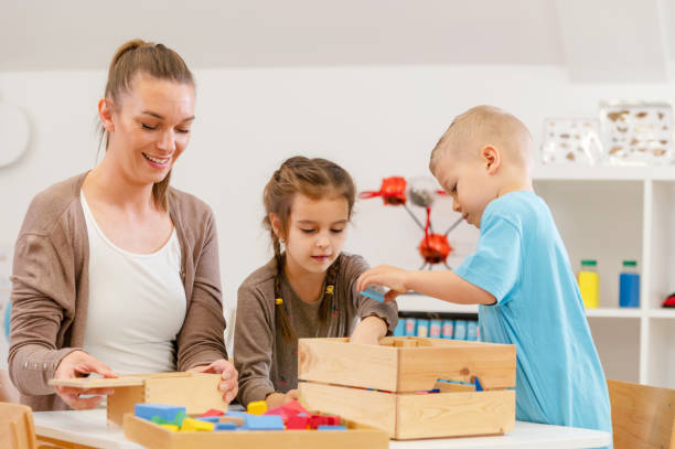 istock Teacher with children in a Kindergarten Classroom. Healthy learning environment 1461186589