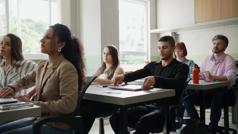 Language teacher beginning a class with a group of adult students