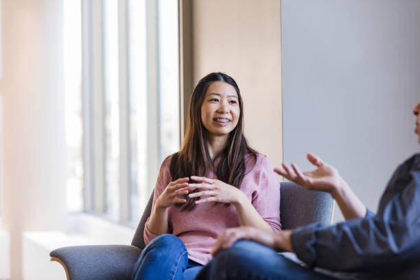 istock Female therapist smiles encouragingly as unrecognizable man shares struggles 1461189343