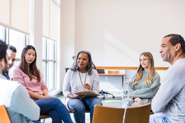 istock Multiracial group listens to unrecognizable man in therapy 1461189345