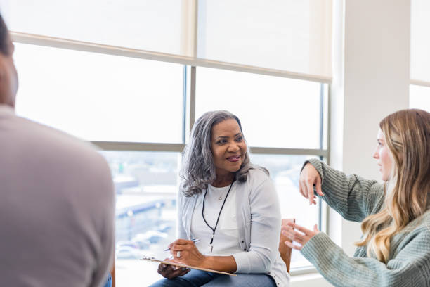 istock Young woman uses gestures to communicate ideas with therapist 1461189379