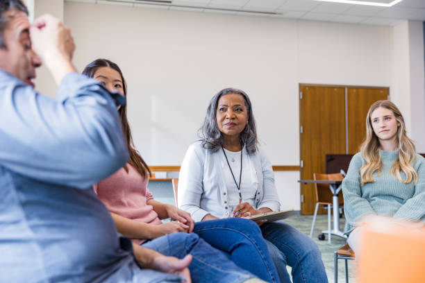 istock Mature man shows emotional stress while sharing in group therapy 1461189410