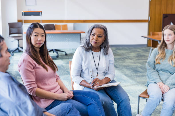 istock Diverse group empathizes with mature man in counseling 1461189414