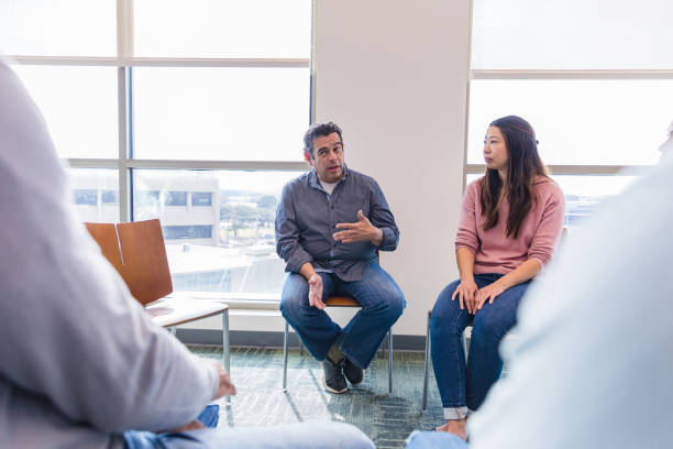 istock Mature man shares with group in counseling session 1461189426