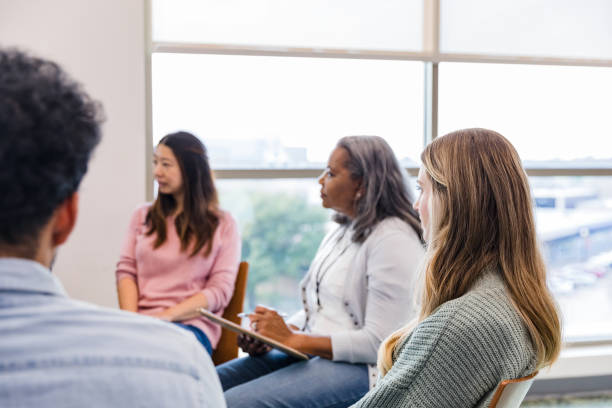 istock Group members listen to ideas from unseen person 1461189439
