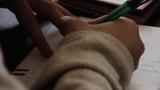 Young Girl Writing a Letter. Close-Up.