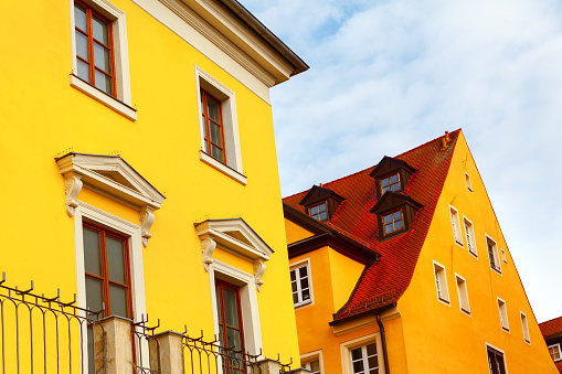 Yellow houses with red roofs . European residential houses
