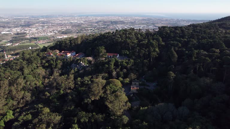 Drone shot revealing the town of Sintra through mountain, Lisbon, Portugal